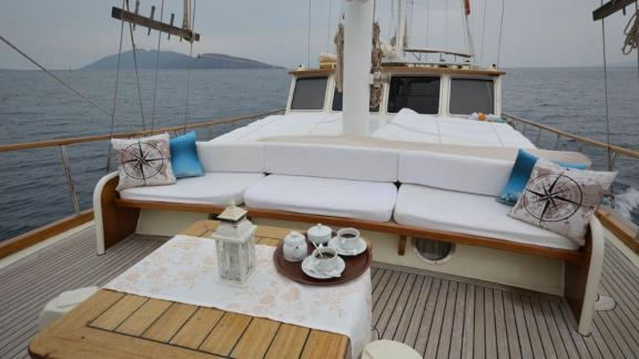 A cozy seating area on the deck of Gulet Tufan 5, perfect for tea and relaxation with a sea view.