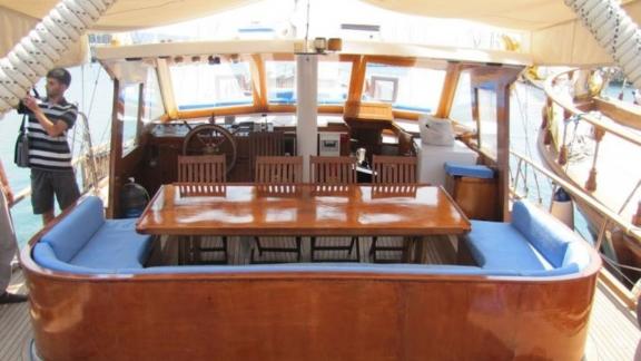 The aft deck of Gulet Valerie features a dining table with ample seating space.