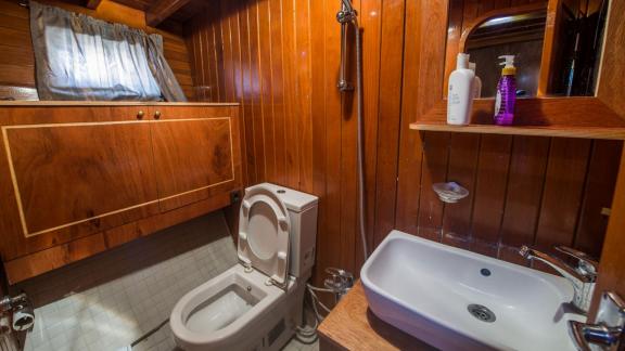 Wooden-designed bathroom on Gulet Valerie with sink and shower.