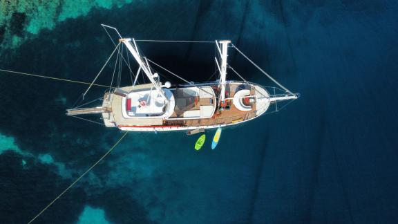 An impressive aerial view of the luxurious gulet Vivere anchored in the clear blue waters of Dubrovnik, Croatia.