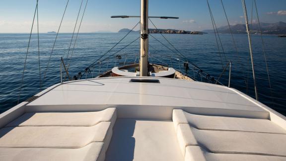 The elegant relaxation area on the deck of the Gulet Vivere overlooks the calm waters and coastline of Dubrovnik, Croati