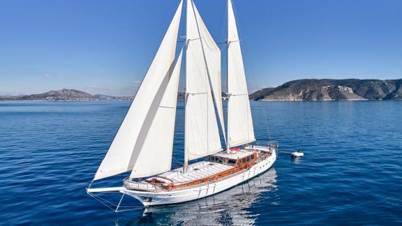 White Pearl gulet is sailing off Athens with full sails raised on calm blue waters.