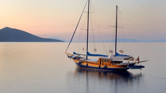 The elegant Gulet Xenos 2 in Bodrum during a picturesque sunset. Perfect for unforgettable experiences.