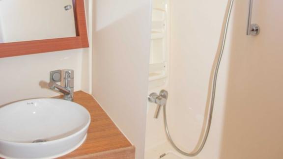 The modern shower area on the Beau Gosse sailing yacht is spacious and practical in design.