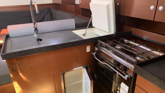 The kitchen area of the Aldebaran sailing yacht is equipped with a sink, stove, and ample counter space.