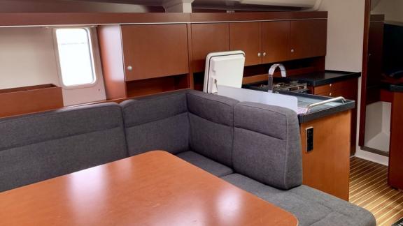 The salon and kitchen area of the Aldebaran sailing yacht is equipped with spacious seating and modern amenities.