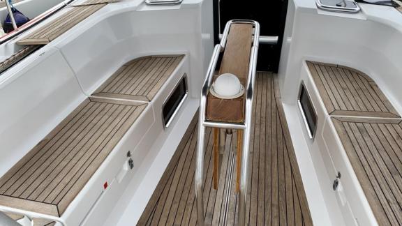 Aft deck of the sailing yacht with wooden seating areas.