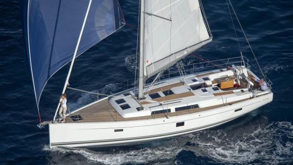 The Deneb sailing yacht is captured from above while cruising at sea.