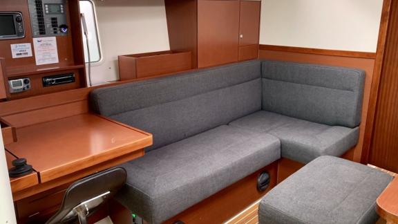 The interior of Baxter sailing yacht features a spacious seating area and a desk for functional use.