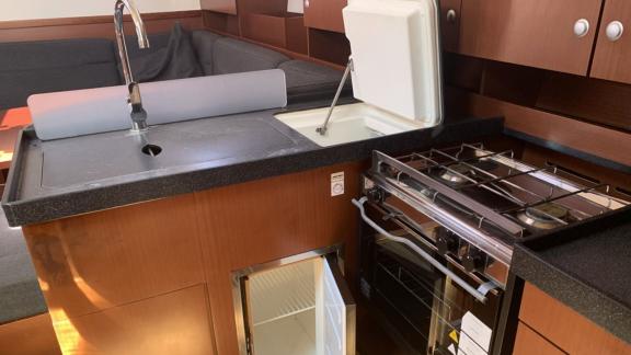 The kitchen of the Taurus 6 yacht features a stove, sink, and fridge.