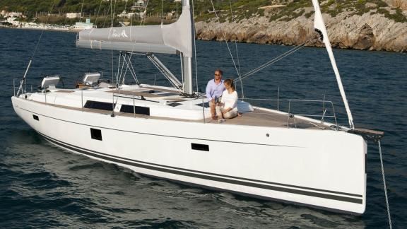 Two people enjoy the view while sitting on the deck of the Taurus 6 yacht.