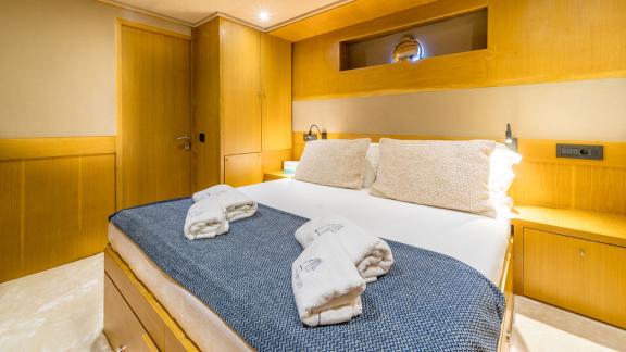 In Fethiye gulet charter option Happy Days cabin with double bed and soft lighting visible.