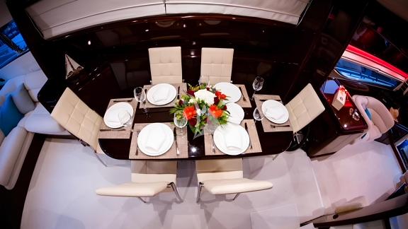 Elegant dining area of the Hasard yacht, decorated with a stylish table and modern chairs.