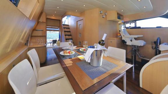 Image of the dining table and seating area with a sea view on Hope I yacht.