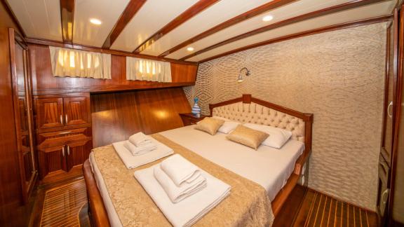 Enjoy the comfort and elegance of the cabin on the Gulet Santa Maria with luxurious furnishings.