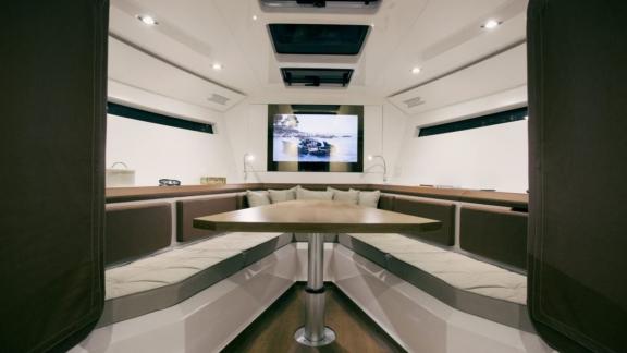 The interior saloon of the Neve motor yacht offers modern design and spacious seating areas for comfort.