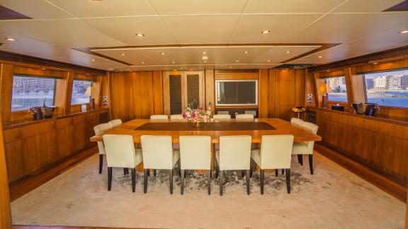 The spacious dining area of Lucien motor yacht offers an unforgettable Dubai yacht rental experience.