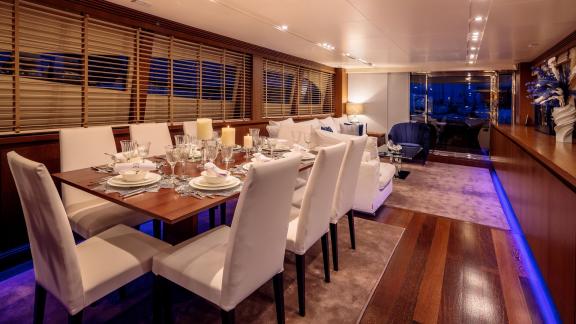 The dining area on yacht Miraval impresses with stylish table settings and modern design.