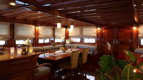 The warm and stylish saloon of Queen Atlantis features comfortable seating and refined details.