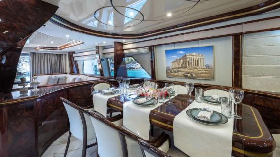 The dining area of Wish Alfamarine 91 features an elegant table setup, white chairs and large side windows.