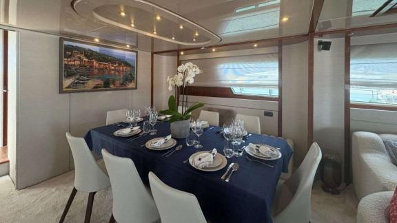 Among Athens yacht options interior dining table and seating area in the salon of Mammas motor yacht.