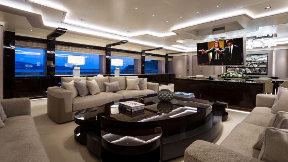 Luxurious cinema on the Opari yacht with elegant furnishings, large screen, and sea views.