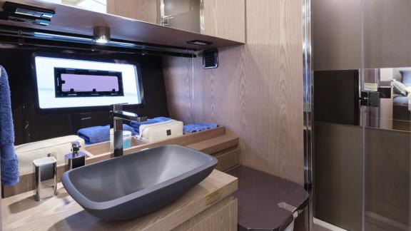 Among Monaco yacht rental options Baccarat motor yacht shows bathroom with sink and shower for comfort.