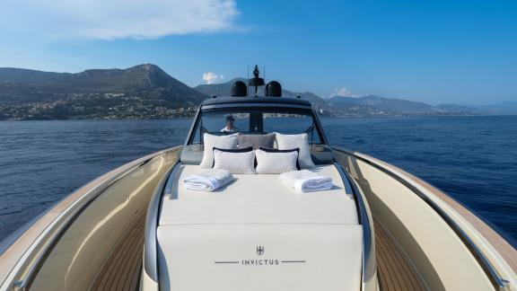 Among Monaco yacht rental options Baccarat motor yacht shows front deck with cushions and open sea view.