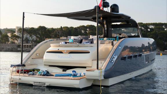 Among Monaco yacht rental options Baccarat motor yacht shows aft deck with sunbed and relaxing seating area.