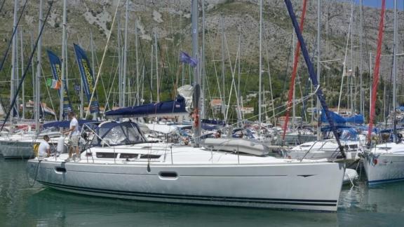 The sailing yacht Winter Breeze is seen leaving the marina among other boats.