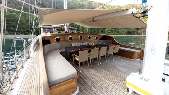 The stylish dining area on the deck of Kayhan yacht, perfect for relaxing evenings.