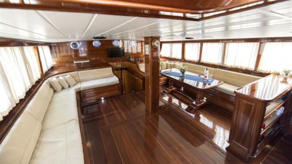 Stylish lounge and dining area inside the Kayhan yacht, perfect for comfortable sea journeys.