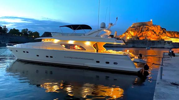 The Kentavros 2 yacht docked in the harbor with night lighting.