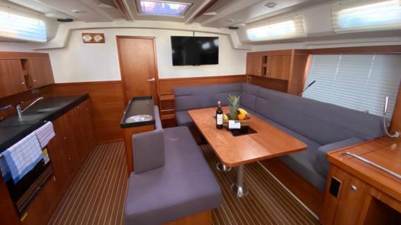 The spacious interior of Kia Ora offers a comfortable dining and seating experience on a bareboat yacht.