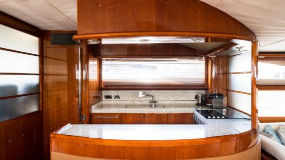 The kitchen of the yacht Azure is equipped with modern appliances and a spacious countertop area.