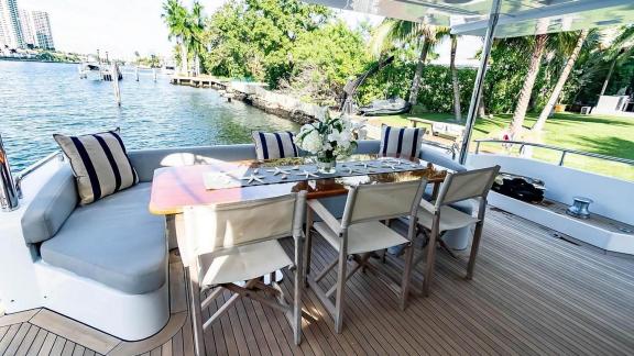 Elegant outdoor dining area on motor yacht La Fenice, perfect for waterside meals.