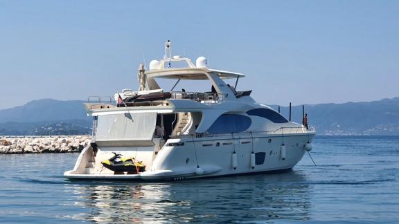 Motor yacht La Fenice with jet ski in calm waters off the coast of Greece.