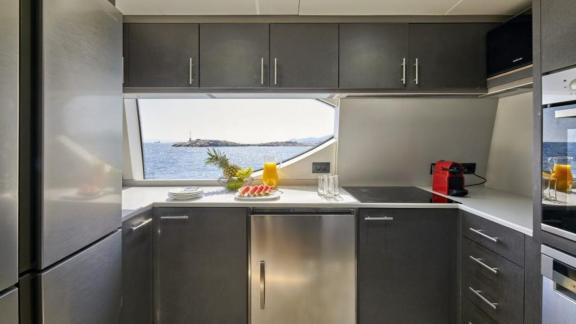 Stylish and well-equipped kitchen on motor yacht La Fenice with sea view.