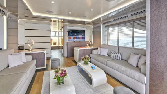 Modern and bright living area with TV on motor yacht La Fenice, perfect for relaxing.