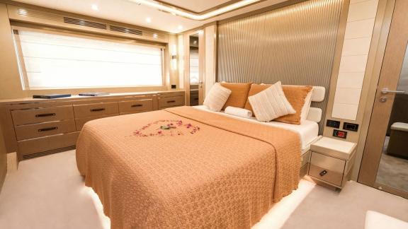 The master cabin on motor yacht La Luna offers luxurious accommodation with a comfortable bed and stylish decor.