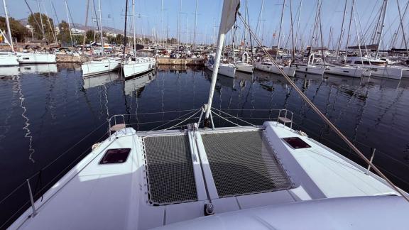 Among Athens bareboat catamaran charter options Bellatrix shows front net deck for relaxing and sailing.