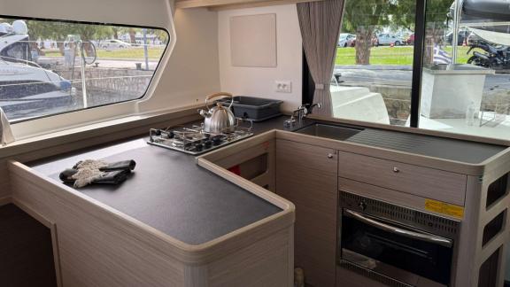 Among Athens bareboat catamaran charter options Bellatrix shows equipped kitchen for comfortable sailing.