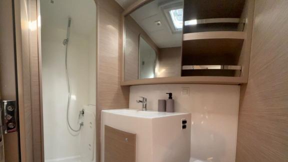 Bellatrix catamaran in Athens features bathroom with shower sink and storage space.