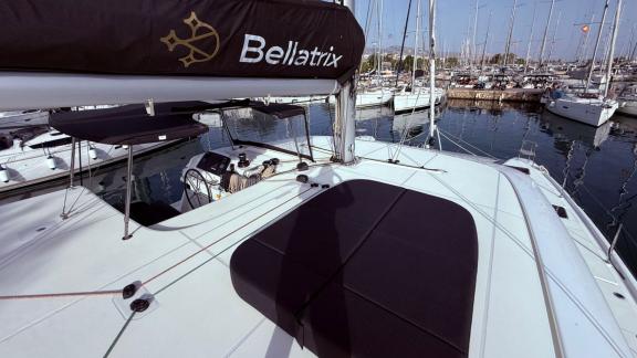 Among Athens bareboat catamaran charter options Bellatrix shows upper deck with sunbed and relaxation space.