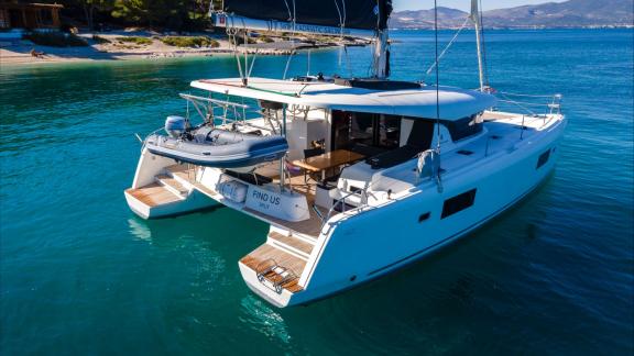 In Kastela bareboat catamaran charter Find Us with aft lounge area and swim platform ideal for relaxing cruise.