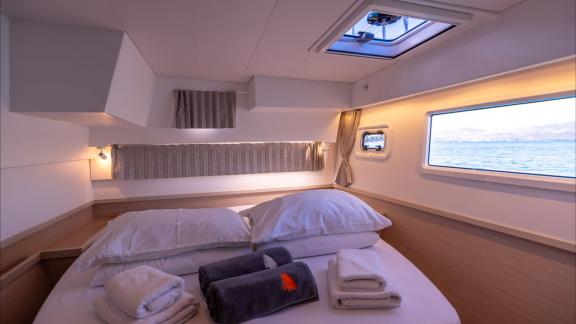 In Kastela bareboat catamaran charter Find Us guest cabin with windows and natural light for comfortable stay.