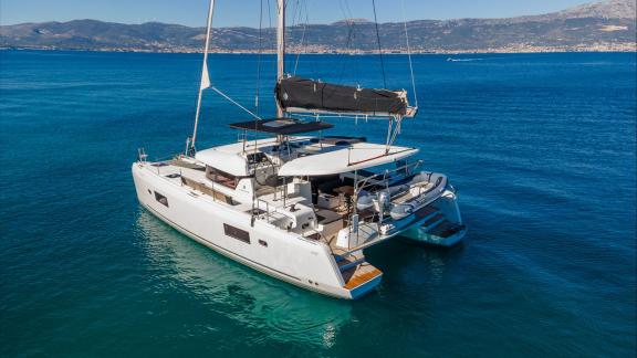 In Kastela bareboat catamaran charter Find Us with swim platform, tender boat and spacious deck for relaxing cruise.