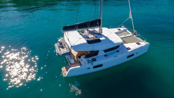 In Kastela bareboat catamaran charter Find Us with sunbathing area, tender boat and spacious deck for relaxing cruise.