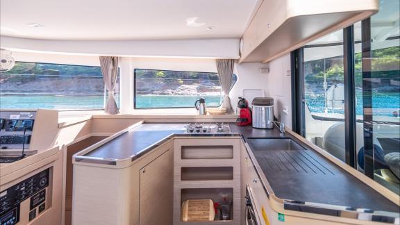 In Kastela bareboat catamaran charter Find Us with kitchen, wide counter space and equipment offering practical comfort.