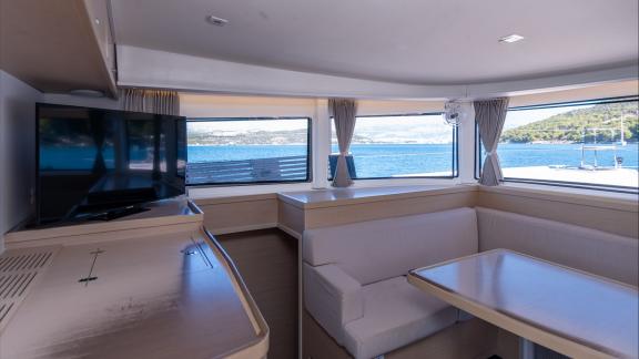 In Kastela bareboat catamaran charter Find Us with saloon seating, table and panoramic windows offering spacious comfort